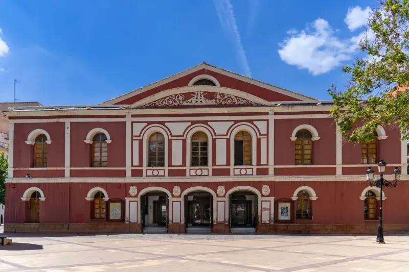 Front view of the historic Teatro Guerra in Lorca, Spain under a clear blue sky.