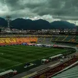 A breathtaking view of El Campin Stadium under a stormy sky in Bogota, Colombia.