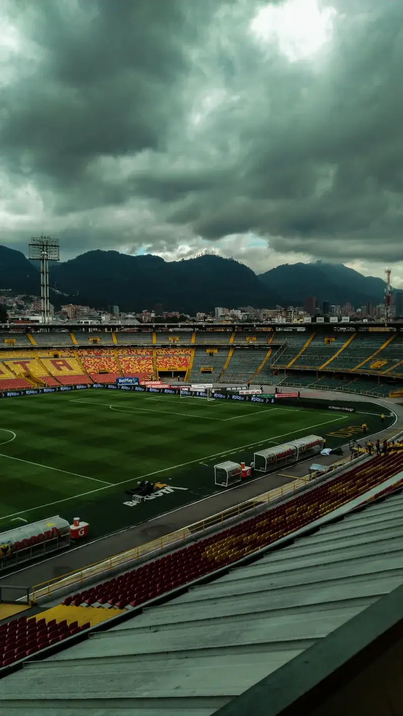 A breathtaking view of El Campin Stadium under a stormy sky in Bogota, Colombia.