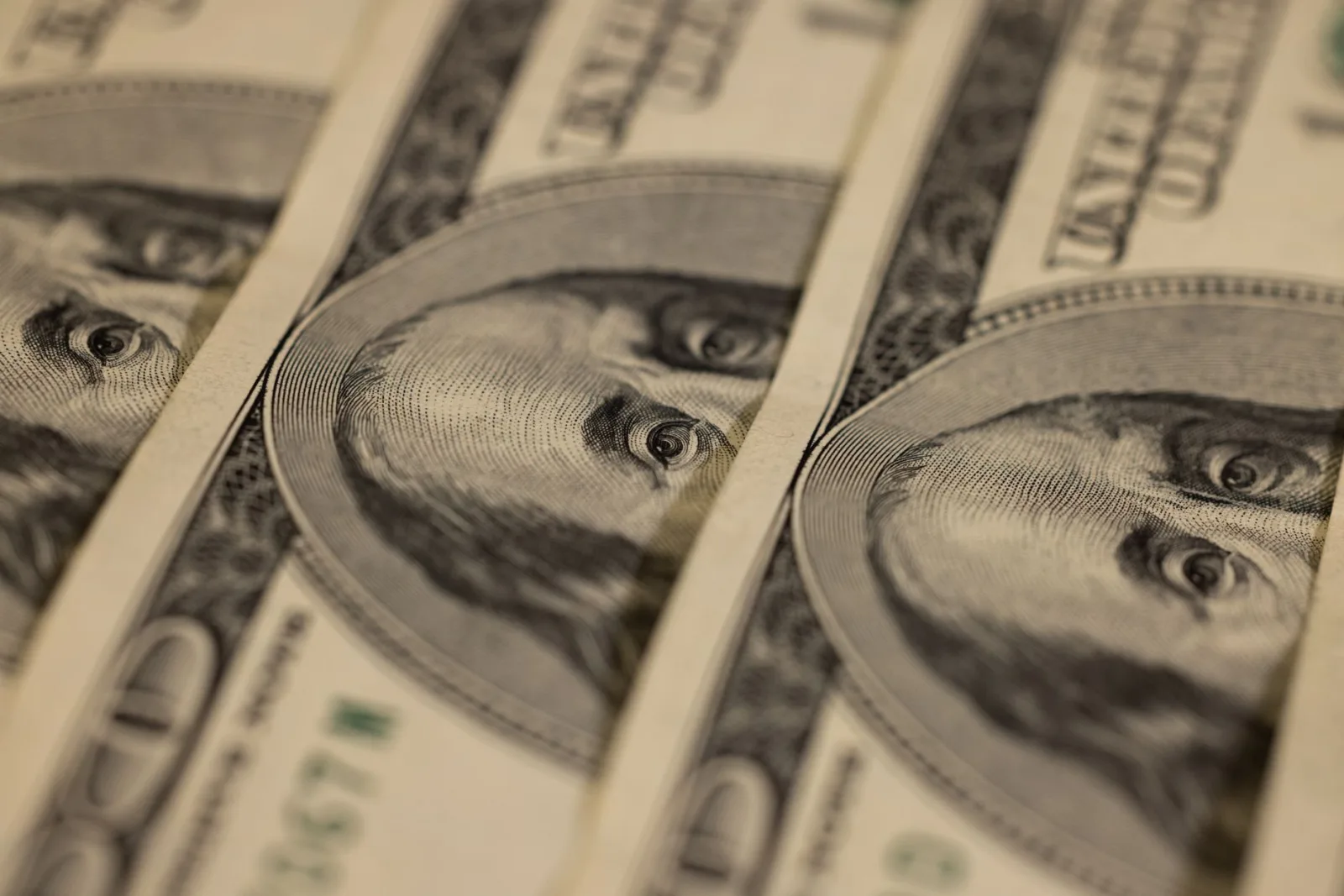 Detailed macro shot of multiple US dollar bills showcasing intricate currency design.