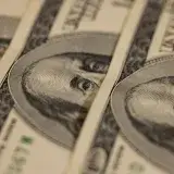 Detailed macro shot of multiple US dollar bills showcasing intricate currency design.
