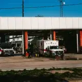 Emergency vehicles parked at a Houston fire station on a sunny day.