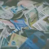 A close-up view of diverse international currency banknotes in soft focus, conveying wealth and finance themes.