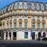 Elegant facade of Hotel Scribe in Paris captured in daylight showcasing classic French architecture.