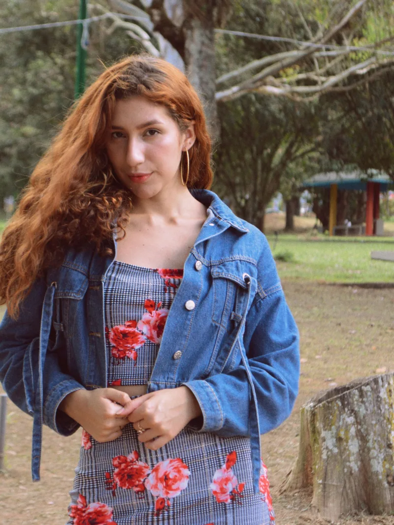 Young woman with red hair posing in a denim jacket outdoors in Táchira, Venezuela.
