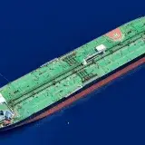 Aerial shot of an oil tanker sailing in the ocean near Vado Ligure, Italy.