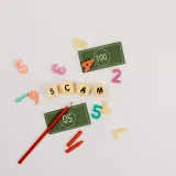 Creative flat lay of scam concept with play money and numbers.