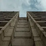 Low angle view of a tall urban building in Mérida, Venezuela against a cloudy sky.