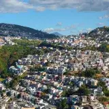 A breathtaking aerial shot of Quito's urban landscape sprawling over lush hills in Ecuador.