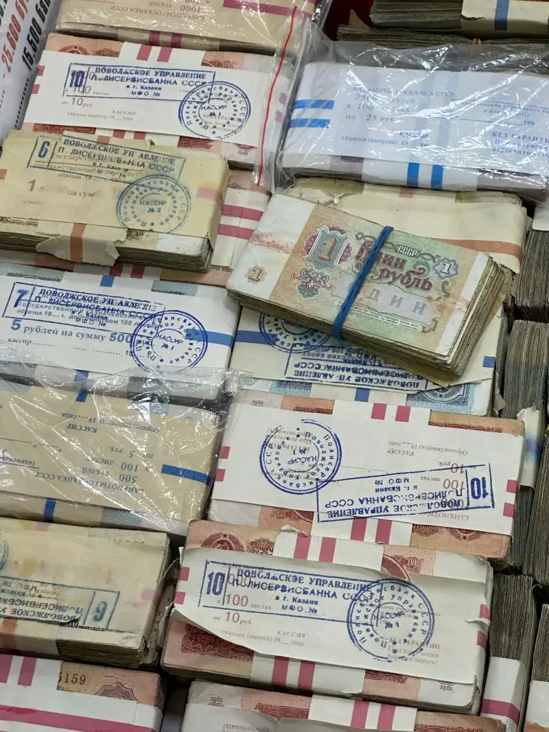 Soviet ruble banknotes wrapped in plastic, showcasing historical currency stacks.