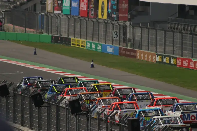 Dynamic truck race at Mexico City's famous Autódromo Hermanos Rodríguez track.
