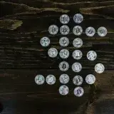Flat lay of Bitcoin coins arranged in a shape on a wooden surface representing digital currency.