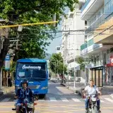 Motorcyclists and a bus on a busy street in Santa Marta, Colombia.