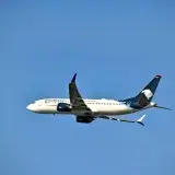 Aeromexico airplane soaring through clear skies over Puerto Vallarta, Mexico.