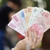 A variety of Turkish Lira in hand, showing multiple banknote denominations.