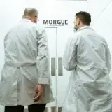 Two doctors entering a morgue, emphasizing a clinical and somber atmosphere.
