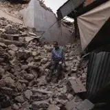 A man sits amidst collapsed buildings and debris following an earthquake in Marrakesh, Morocco.