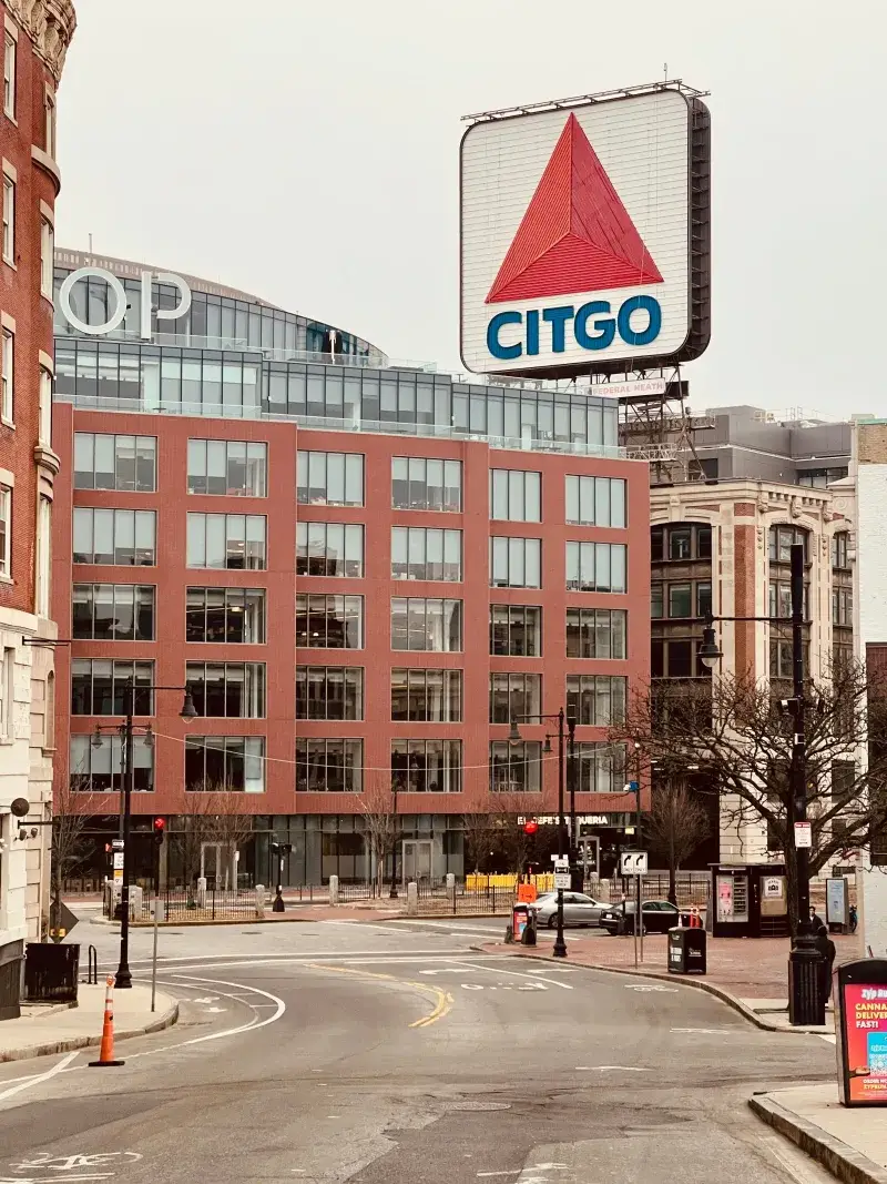 Urban street view featuring the famous CITGO sign, Boston's landmark.