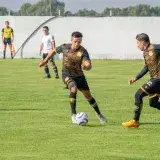 Soccer players in action during a daytime match, displaying teamwork and strategy.