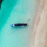 Overhead view of a lone boat in the clear turquoise waters of Ocho Rios, Jamaica.