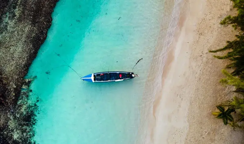 Overhead view of a lone boat in the clear turquoise waters of Ocho Rios, Jamaica.
