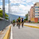 Cyclists riding on a city street in Mérida, Venezuela, showcasing vibrant urban life.