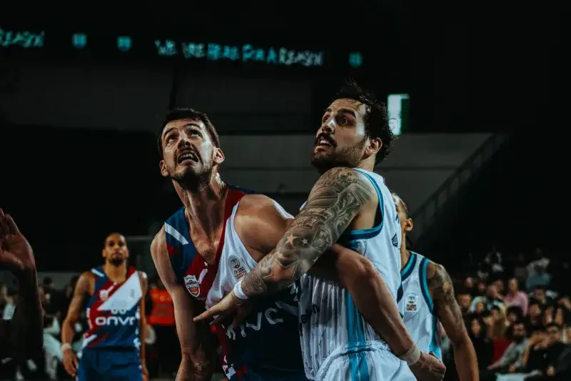 Two male basketball players in action during an intense game. Competitive sports photography.