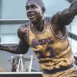 Bronze statue of famous basketball player in Lakers jersey outside Staples Center, Los Angeles.