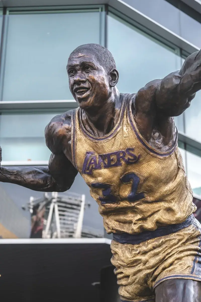 Bronze statue of famous basketball player in Lakers jersey outside Staples Center, Los Angeles.