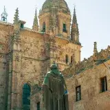 Statue of Fray Luis de León in front of Salamanca Cathedral's Gothic architecture.