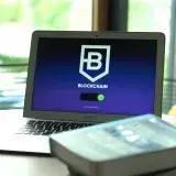 Laptop displaying blockchain connecting screen in modern setting.