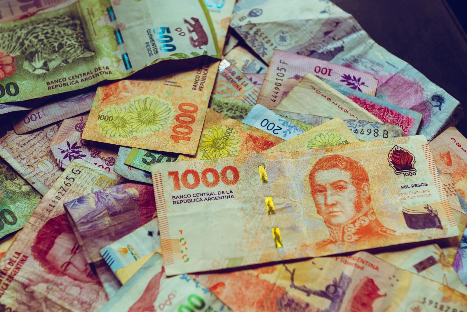 A vibrant collection of Argentine peso banknotes showcasing diverse designs and denominations.