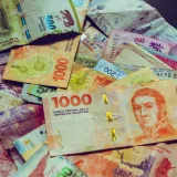A vibrant collection of Argentine peso banknotes showcasing diverse designs and denominations.