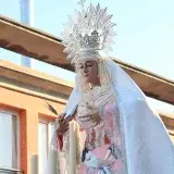 A religious statue of the Virgin Mary during a procession in El Puerto de Santa María, Spain.