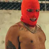 A bold street fashion portrait of a man wearing a red mask in Medellín, Colombia.