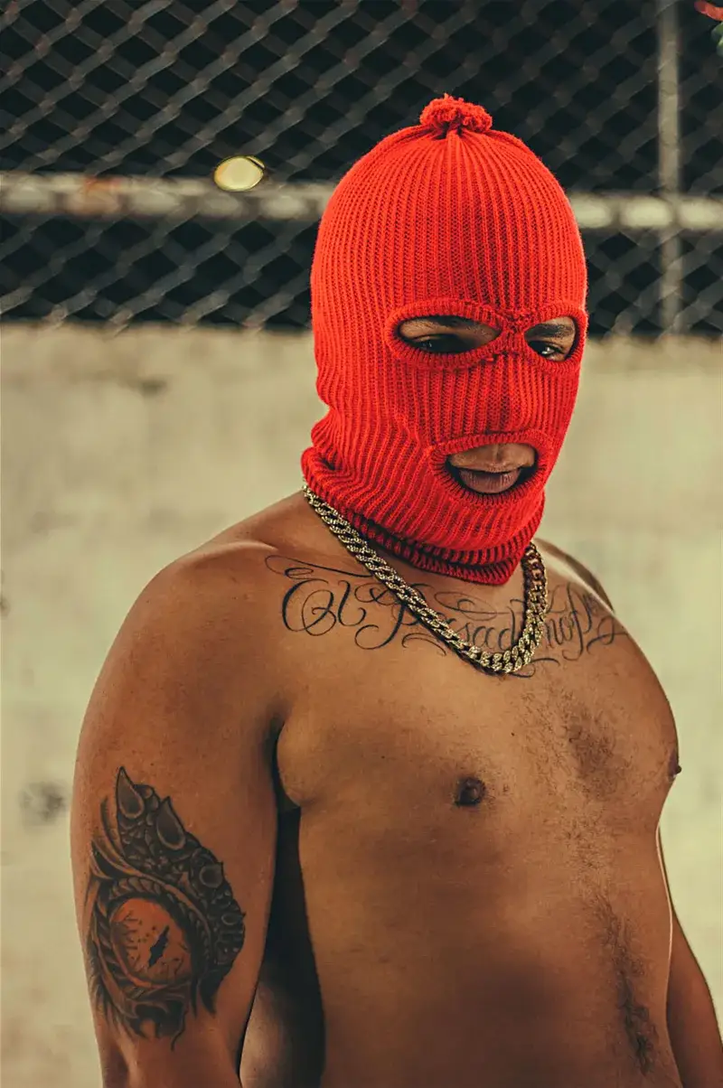 A bold street fashion portrait of a man wearing a red mask in Medellín, Colombia.