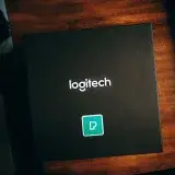 Top view of a Logitech branded box with design elements on a wooden surface, perfect for showcasing product packaging.