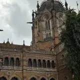 Gothic architecture of Saint Xavier's College in Mumbai, featuring ornate details and lush surroundings.