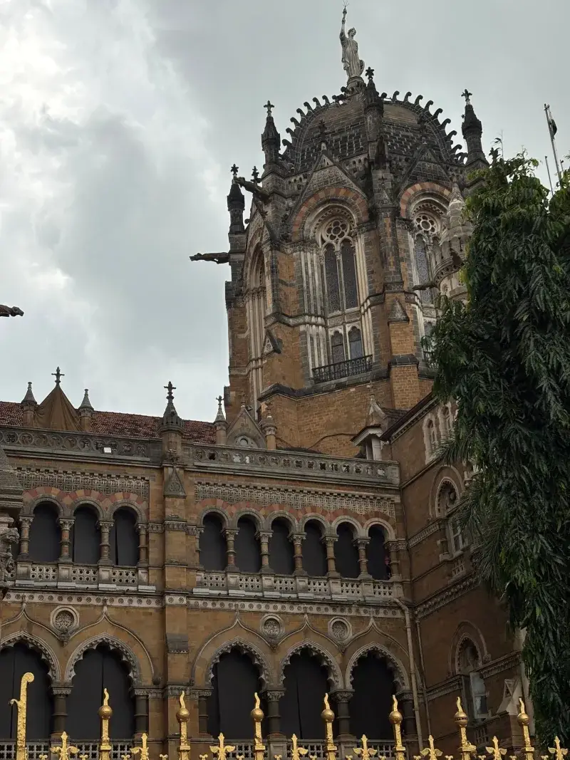 Gothic architecture of Saint Xavier's College in Mumbai, featuring ornate details and lush surroundings.