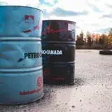 two gray and black metal barrels under cloudy sky