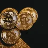 A detailed close-up shot of shiny bitcoin coins resting on a glittery surface, symbolizing wealth in digital currency.