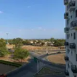 View of a cityscape from a high-rise in Venezuela, capturing roads, buildings, and green spaces.