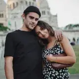 Happy couple enjoying a moment at Sacré-Cœur Basilica, Paris, France.