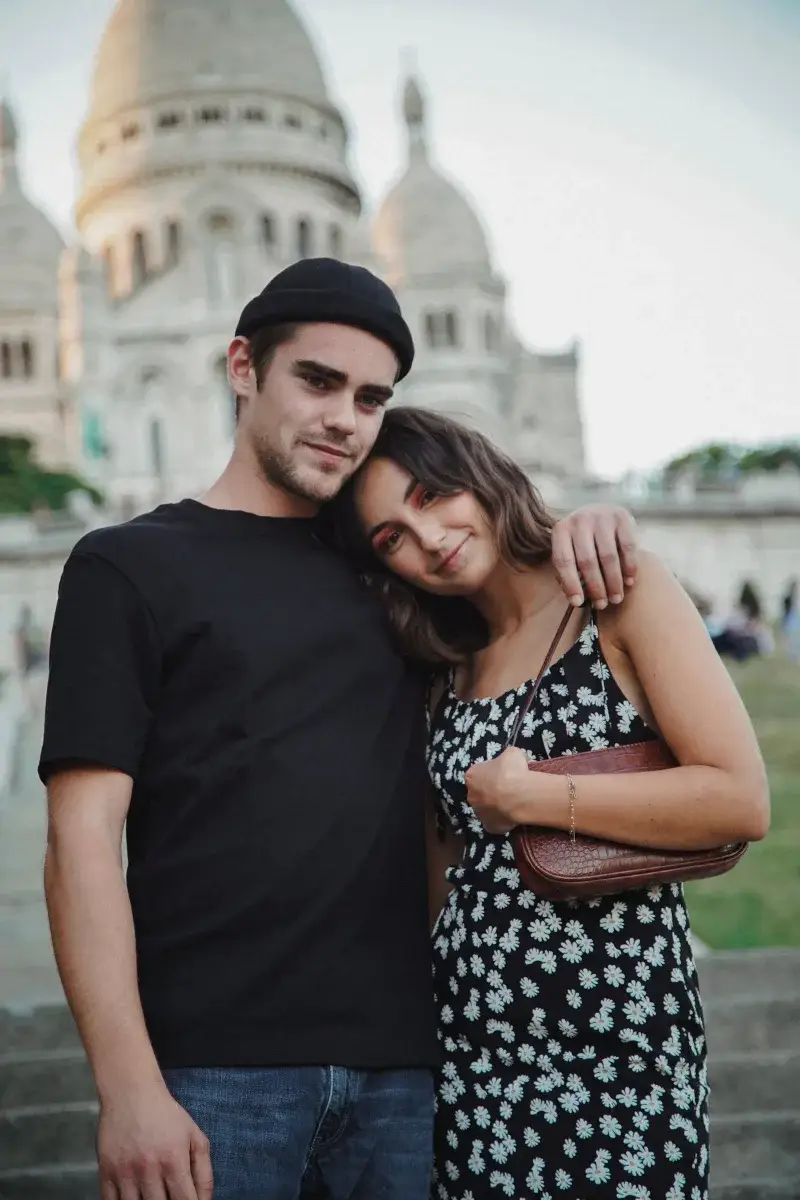 Happy couple enjoying a moment at Sacré-Cœur Basilica, Paris, France.