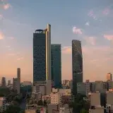 Stunning view of high-rise buildings in Ciudad de México at sunset, featuring Torre Reforma and Torre BBVA.