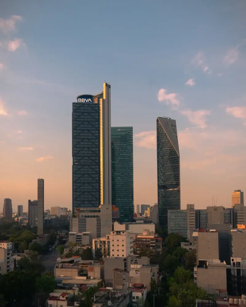 Stunning view of high-rise buildings in Ciudad de México at sunset, featuring Torre Reforma and Torre BBVA.
