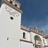 An architectural view of the Basilica of Our Lady of Copacabana under a clear blue sky in Bolivia.