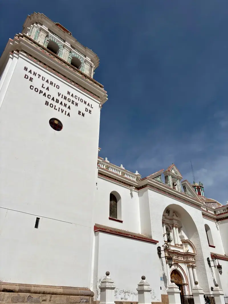 An architectural view of the Basilica of Our Lady of Copacabana under a clear blue sky in Bolivia.