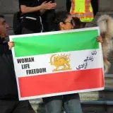 People holding signs for the Woman Life Freedom protest in Vancouver, Canada.