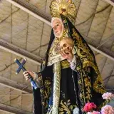 Close-up of Saint Rita statue during a religious procession in Guiguinto, Philippines.